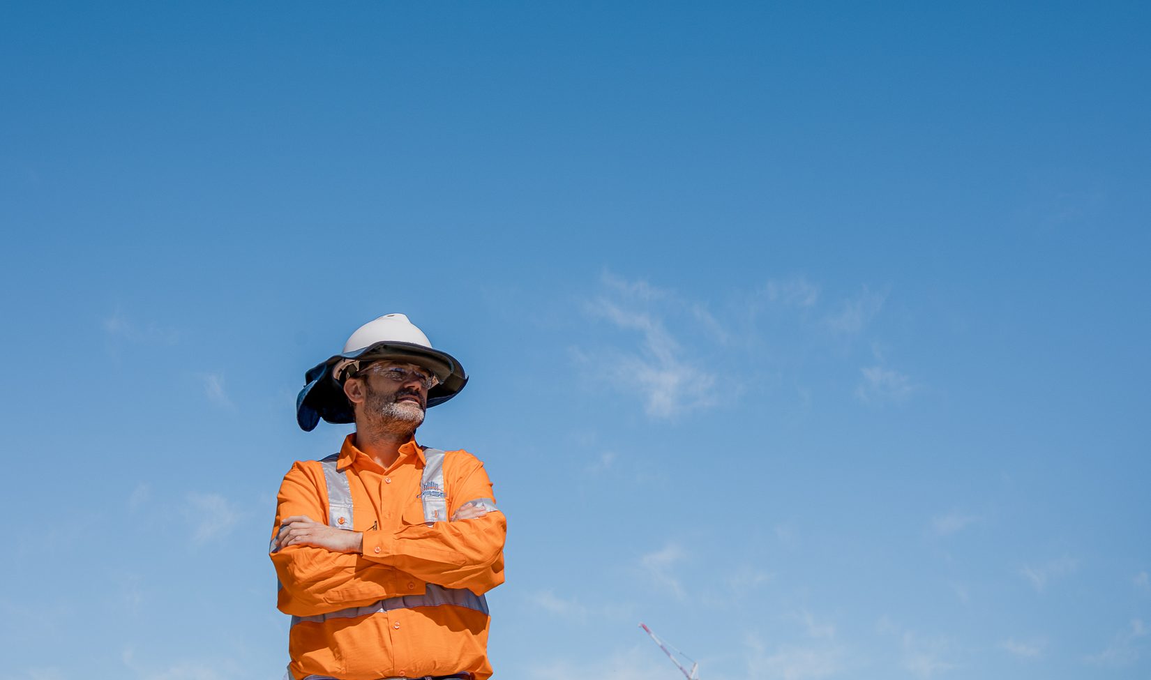 case civil and structural engineer on site photos with hard hat with phone logo showcasing new website and five years anniversary with a world map background in blue