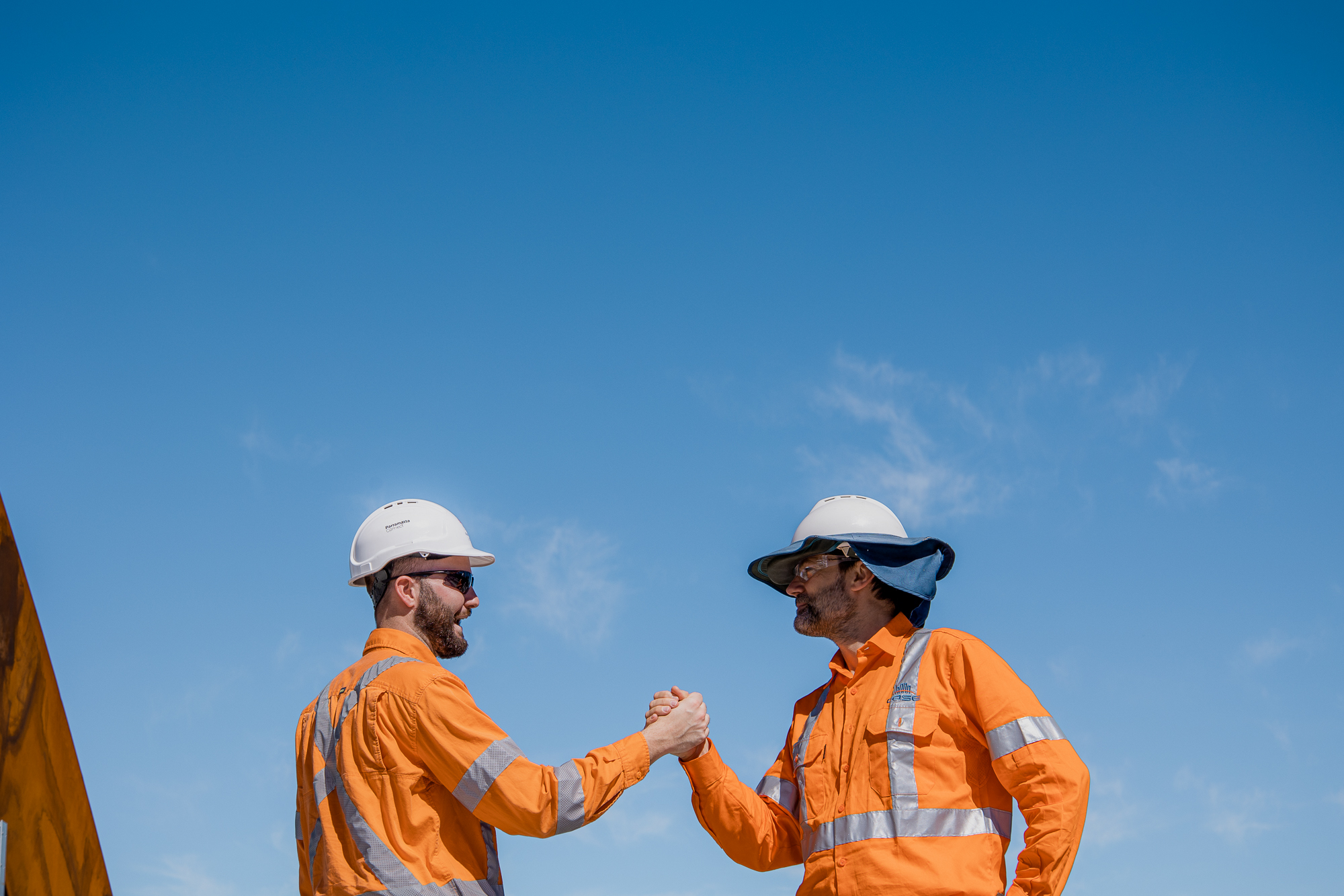 case civil and structural engineer on site photos with hard hat with phone logo showcasing new website and five years anniversary with a world map background in blue
